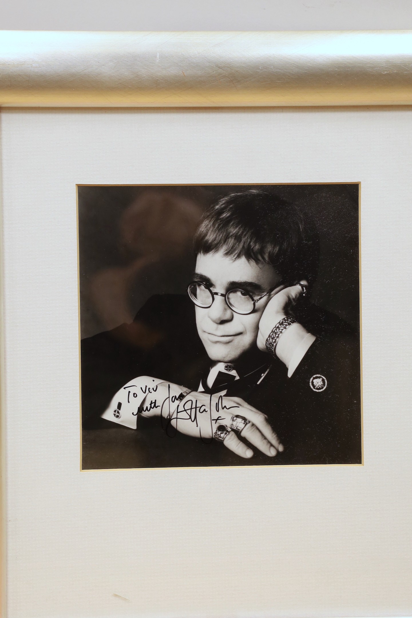 A collection of mostly framed autographs to include an event card from Elton John, 25 March 1994 signed by Charlie Watts, Jerry Hall and Jerry Hall, together with autographs by David Bowie, Phil Collins, David Bailey, Da